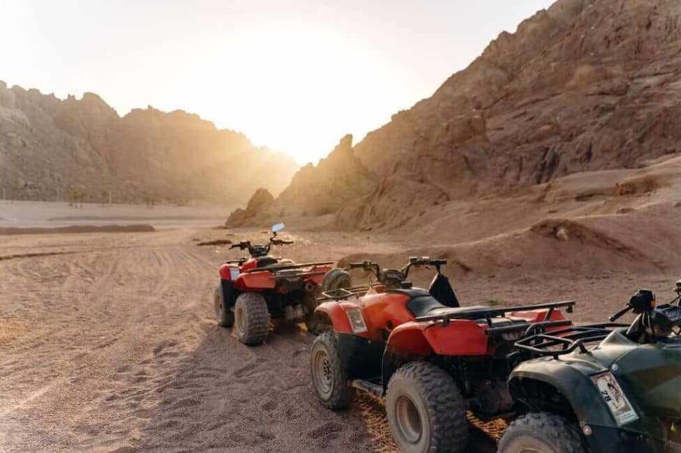 Colonne de buggy dans le désert au coucher du soleil